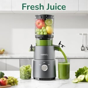 “Canoly C03 Cold Press Juicer on a kitchen counter surrounded by fresh fruits and vegetables, showing its wide 4.5‑inch feed chute and modern matte grey design.”